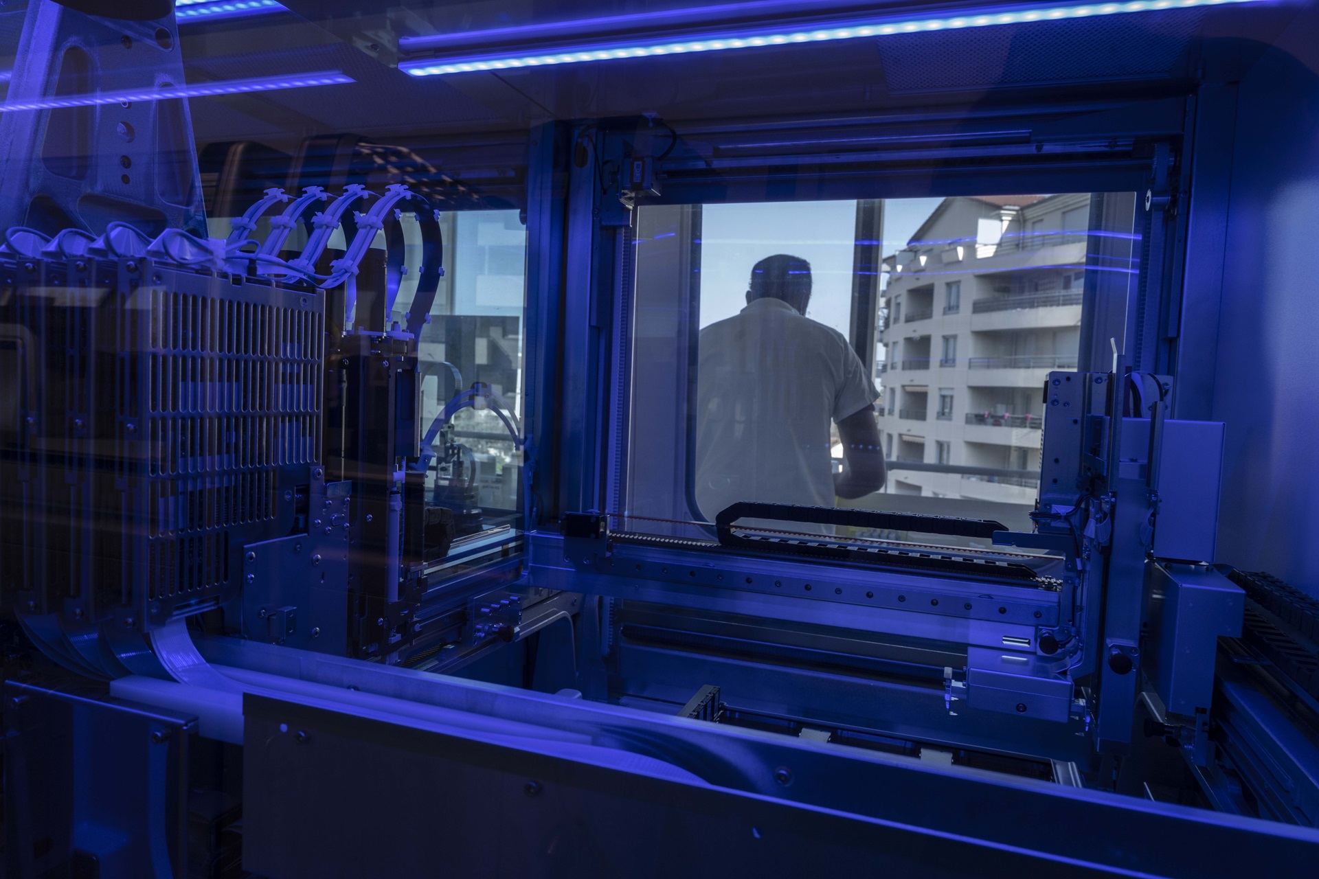 Influenza-2022-France A lab technician at work, seen through the automated PCR system instrument