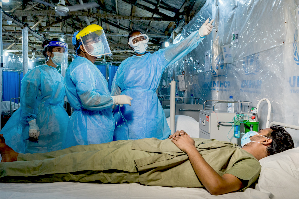 COVID-19 Bangladesh WHO Infection Prevention and Control Specialist Rebecca Rachel Apolot, center, visits a COVID-19 patient shortly before he is discharged from a Severe Acute Respiratory Infection Isolation and Treatment Center (SARI ITC) facility