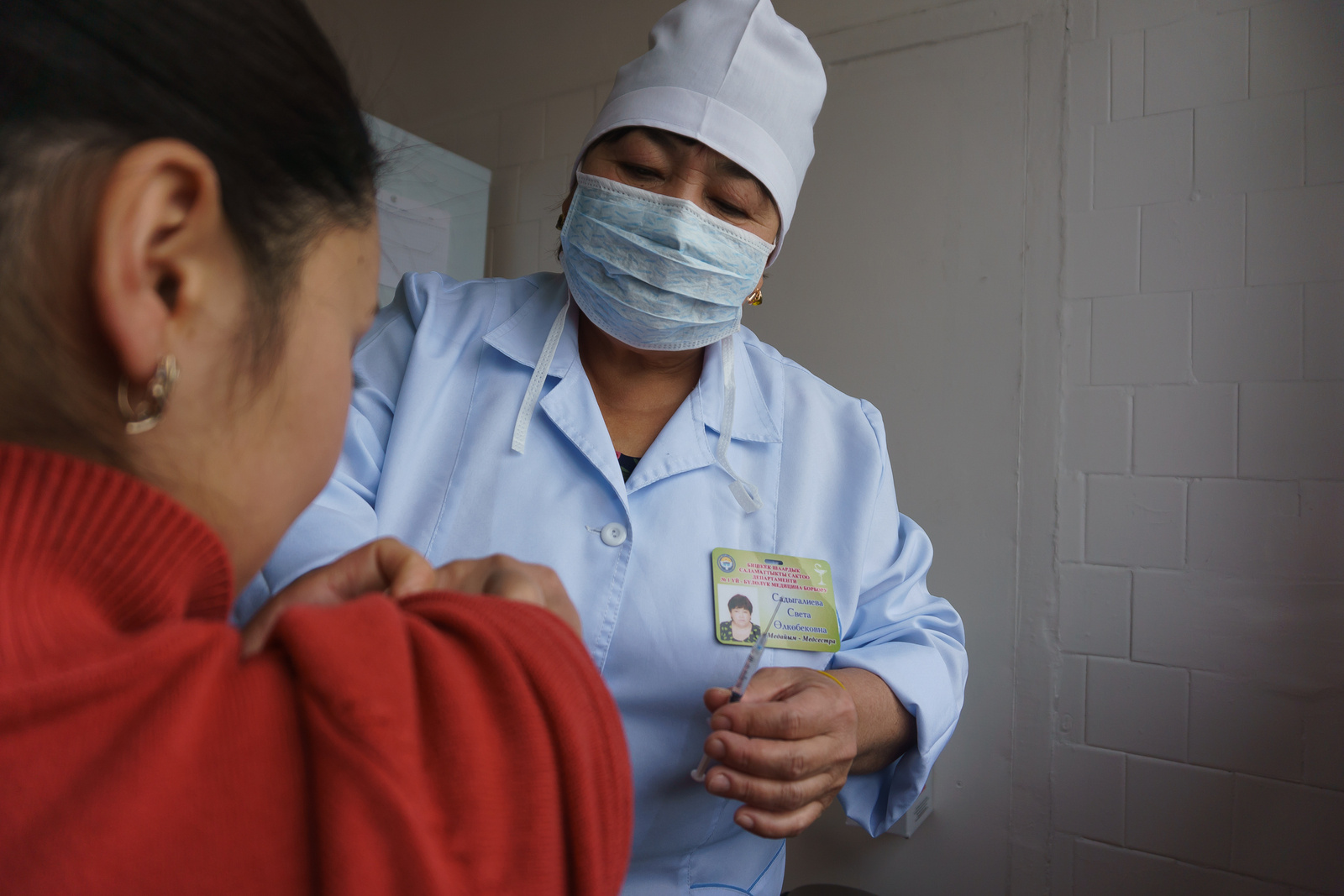 Health worker administering a vaccination at a medical centre in Bishkek in Kyrgyzstan
