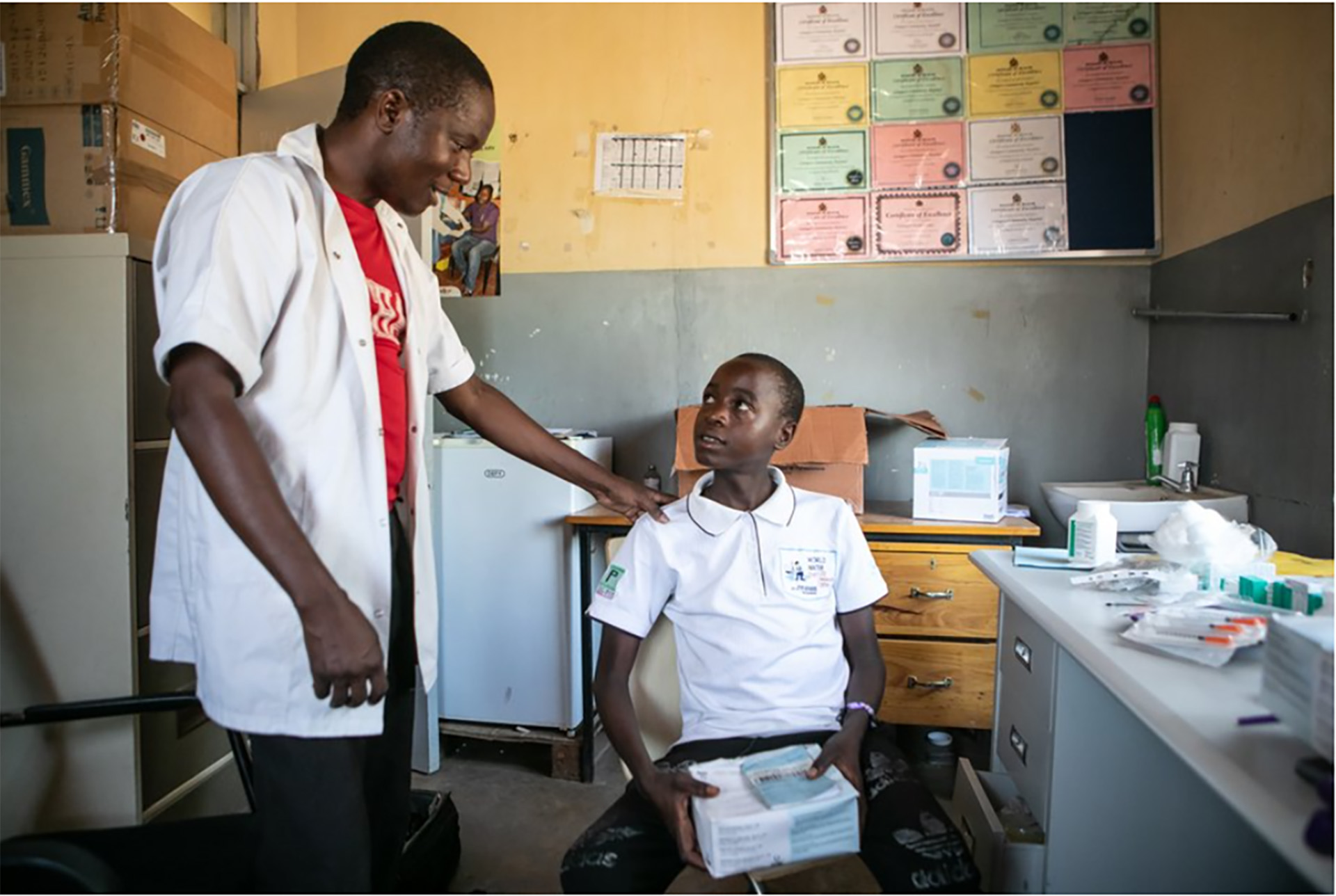 news-access-to-medicines a health worker talking to a child in a clinic