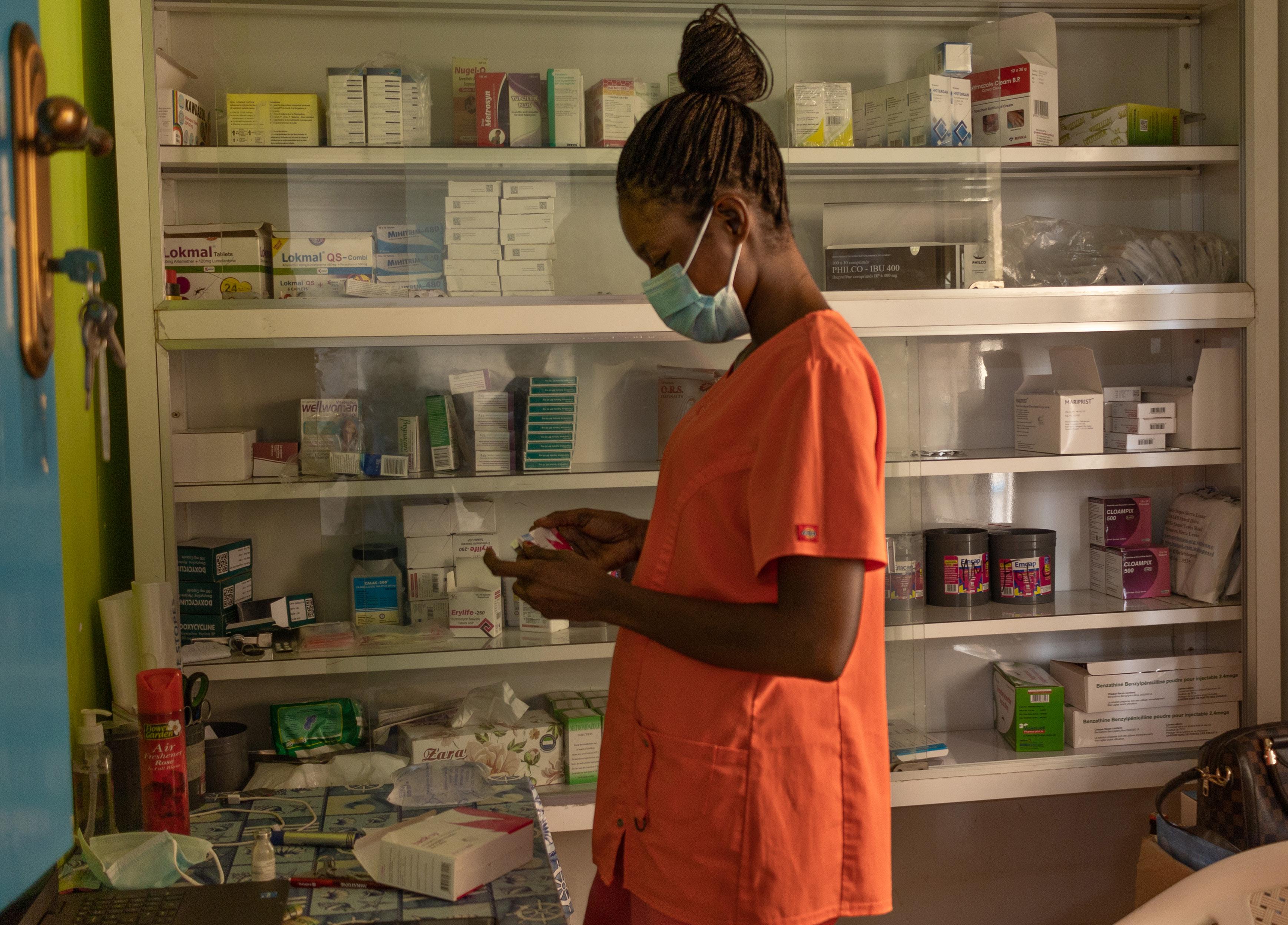 A nurse manages the stock of emergency contraception at a dispensary in Sierra Leone.