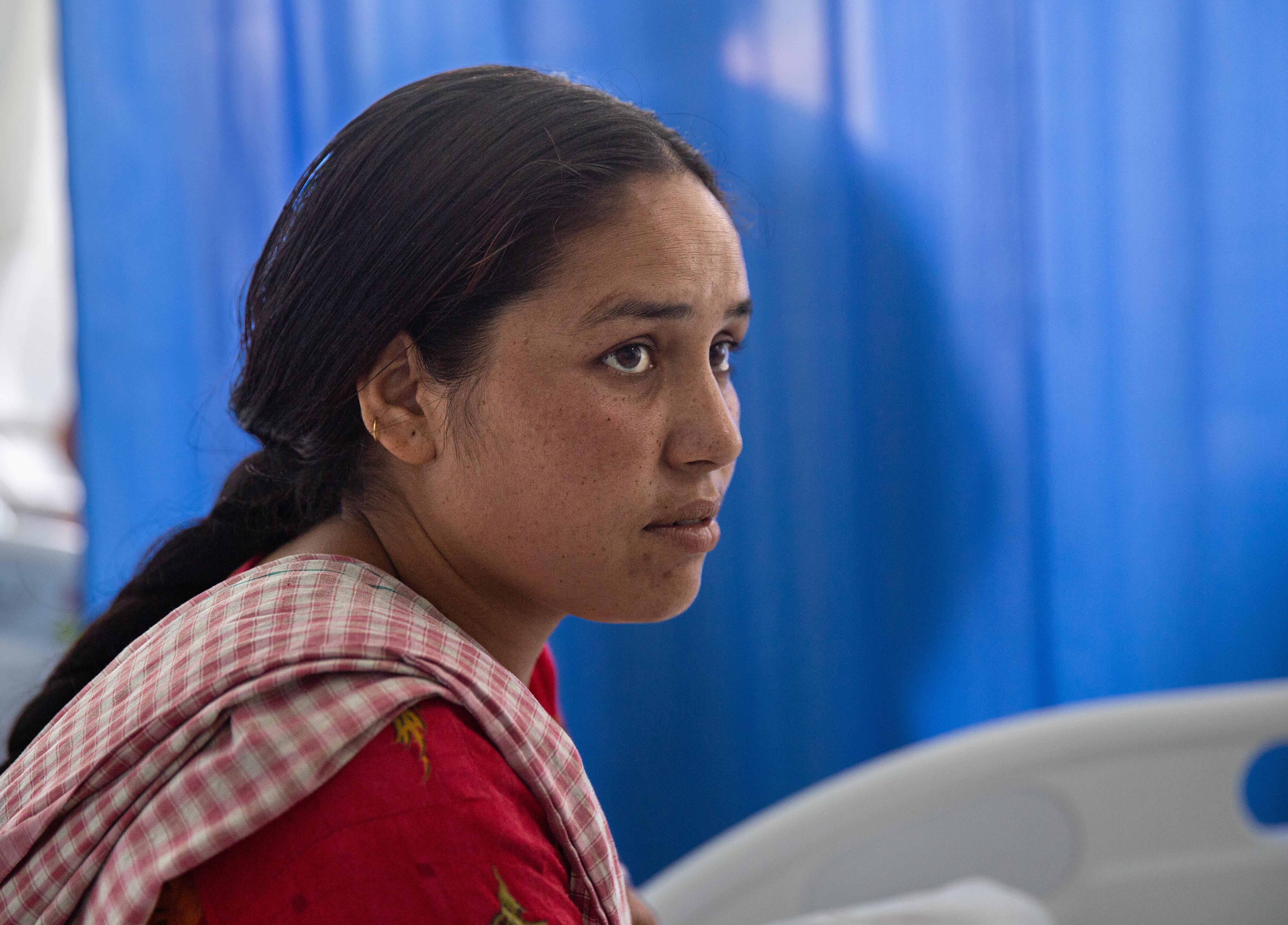 Dhriti, mother of two, recovers in a hospital in Nepal. She arrived in a critical condition, following an unsafe abortion.