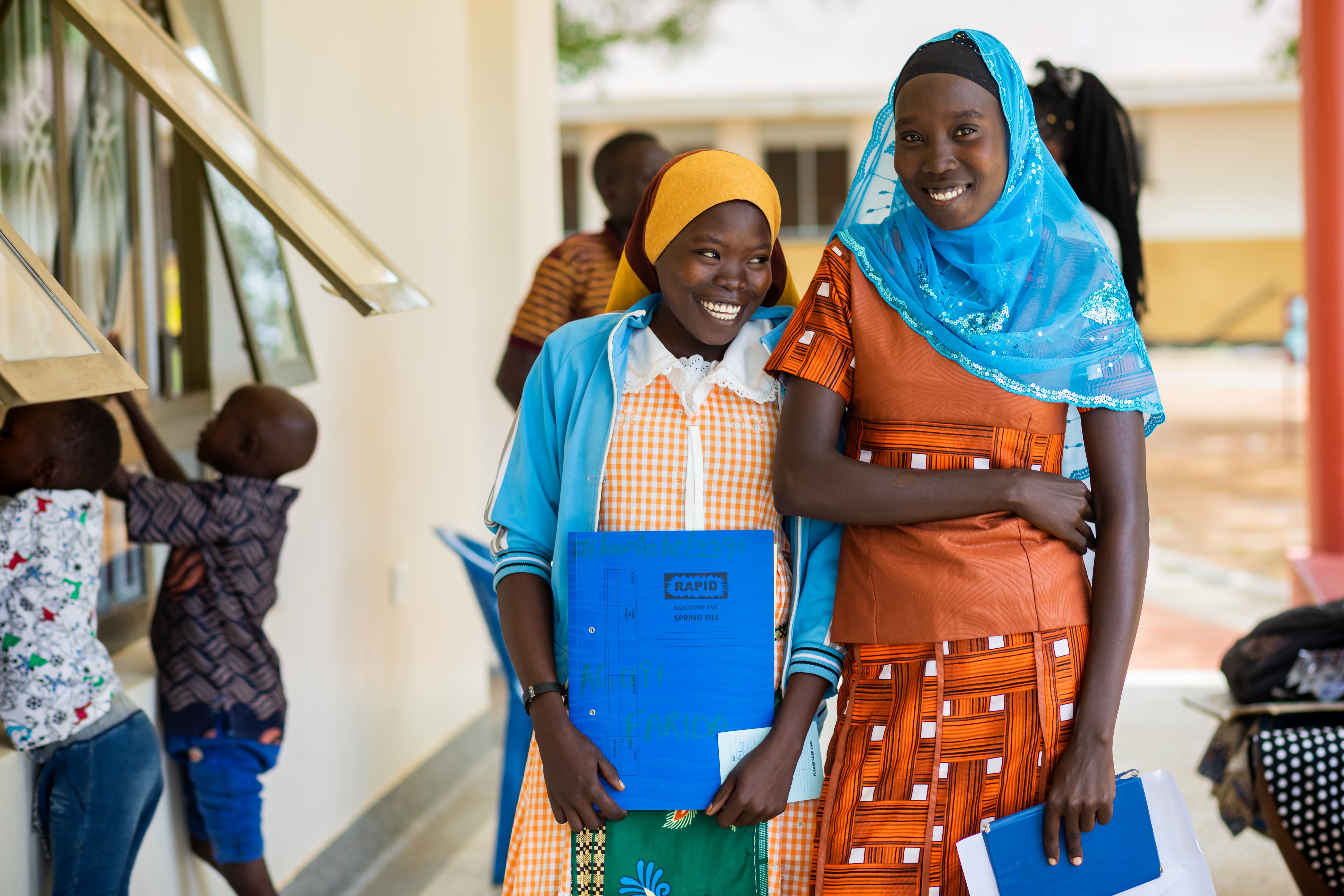Farida, 18 (left), and her sister Rukia, 22 (right), outside Atutur General Hospital, Kumi, Uganda.