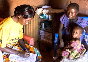 Mother and child with community health worker in the Democratic Republic of the Congo